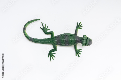 green toy lizard on a white background