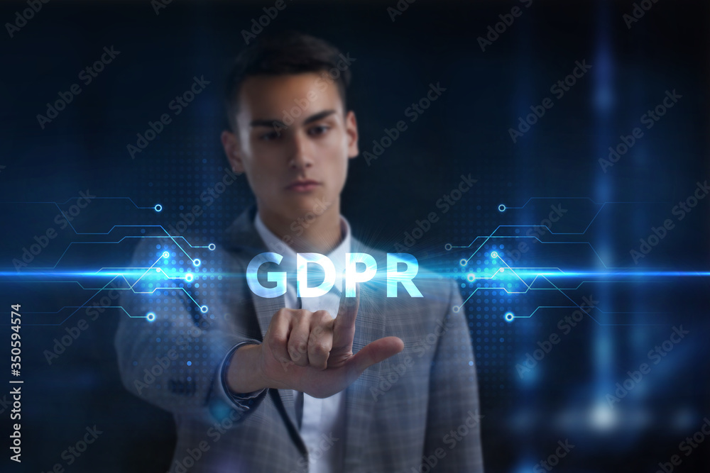 Business, Technology, Internet and network concept. Young businessman working on a virtual screen of the future and sees the inscription: GDPR Business, Technology, Internet and network concept. Young businessman working on a virtual screen of the future and sees the inscription: GDPR