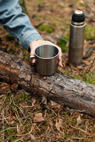 Wallpaper Mural A girl drinking tea from a thermos. Tea from the thermos in the woods. Drinking from the thermos. The forest atmosphere.  Torontodigital.ca