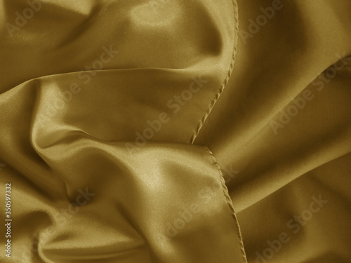 Shiny gold crumpled fabric combinated with matte one. photo