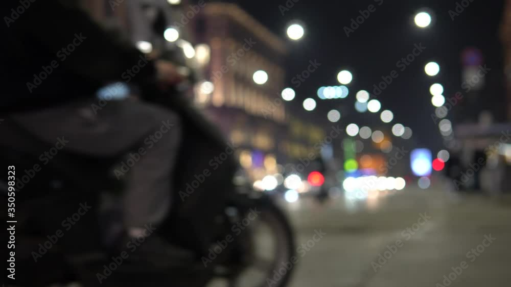 Defocused Milano traffic lights and cars at night. Blurred image of Milan, street - Corso Buenos Aires. Defocused Milano traffic lights and cars at night. Blurred image of Milan, street - Corso Buenos Aires.