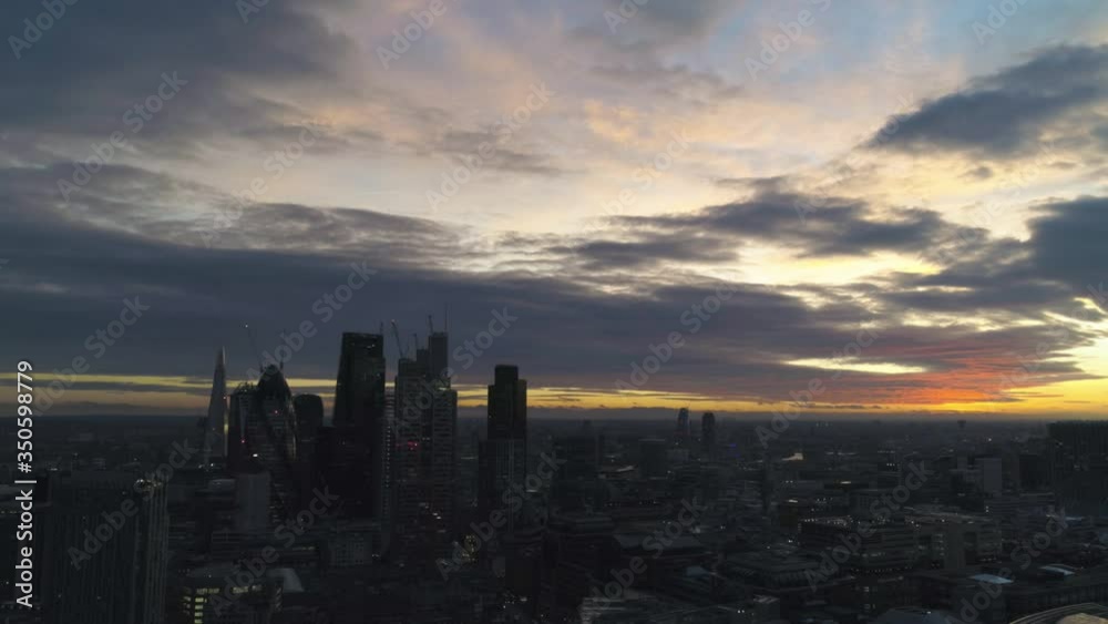 London skyline at dusk looking toward sunset with city lights turning on London skyline at dusk looking toward sunset with city lights turning on