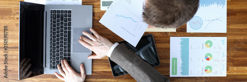 Men coordinate work on documents electronically photo