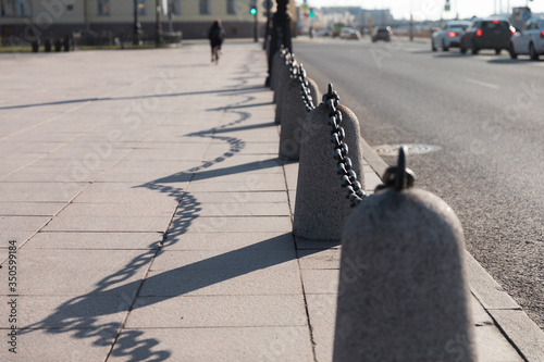 Road fencing Granite posts with a large iron chain