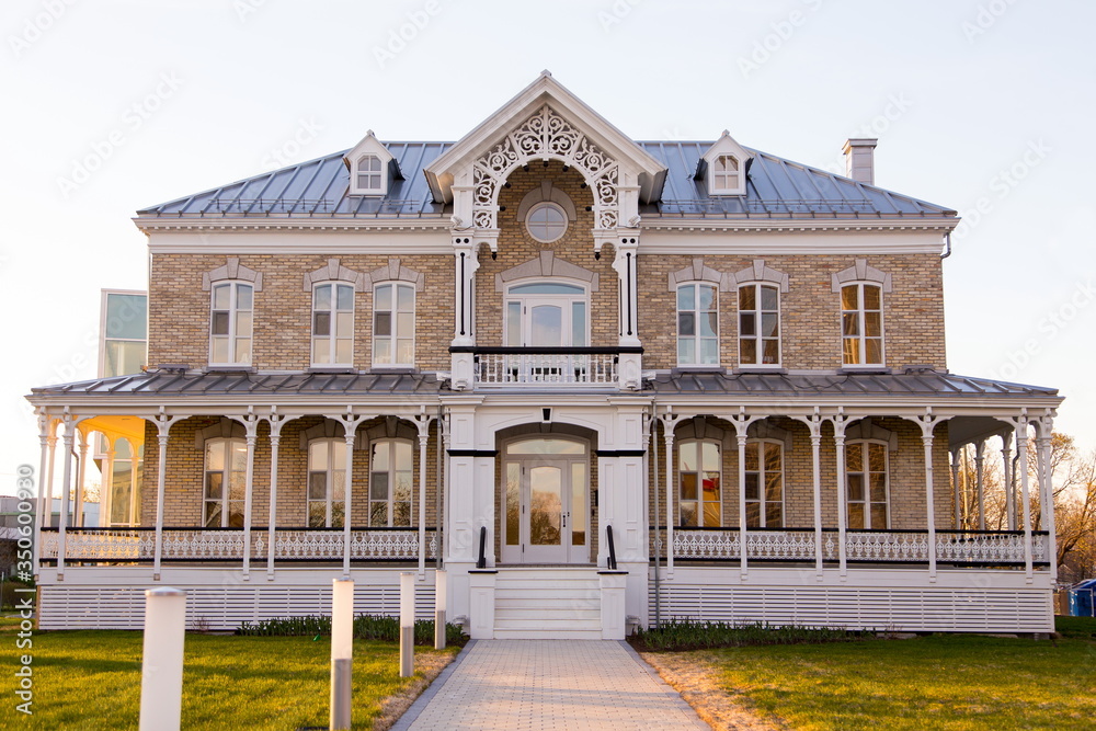 Horizontal frontal view of the 1893 italianate two story Notre-Dame-de-l’Annonciation presbytery in L’Ancienne-Lorette, small town in the vicinity of Quebec City, Quebec, Canada