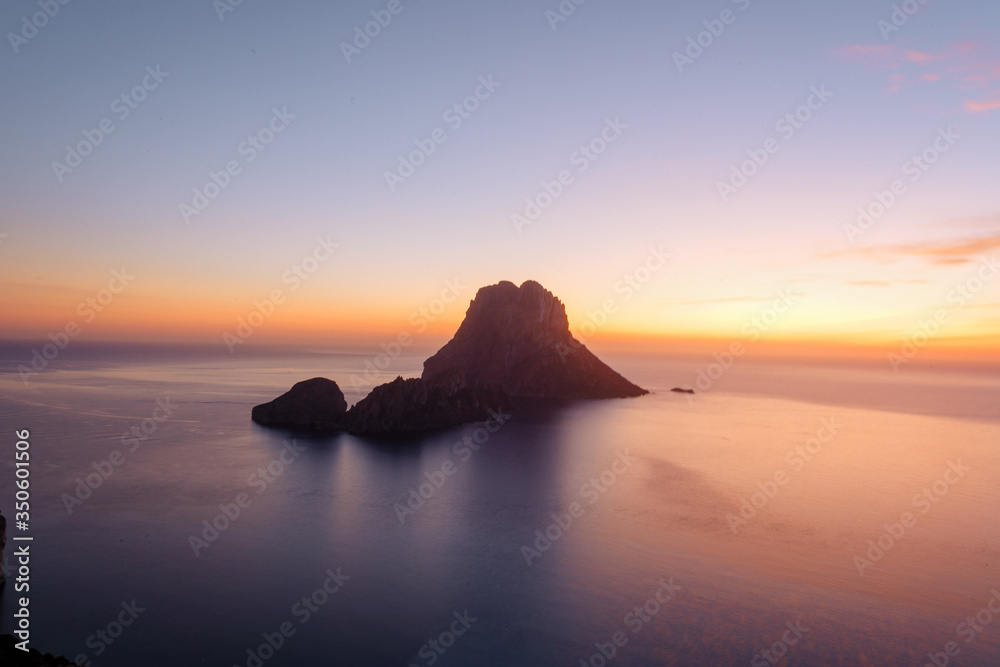 Es Vedra at the sunset, pastel colored sky at the mystic rock of Es Vedra, Ibiza Island. Es Vedra at the sunset, pastel colored sky at the mystic rock of Es Vedra, Ibiza Island.