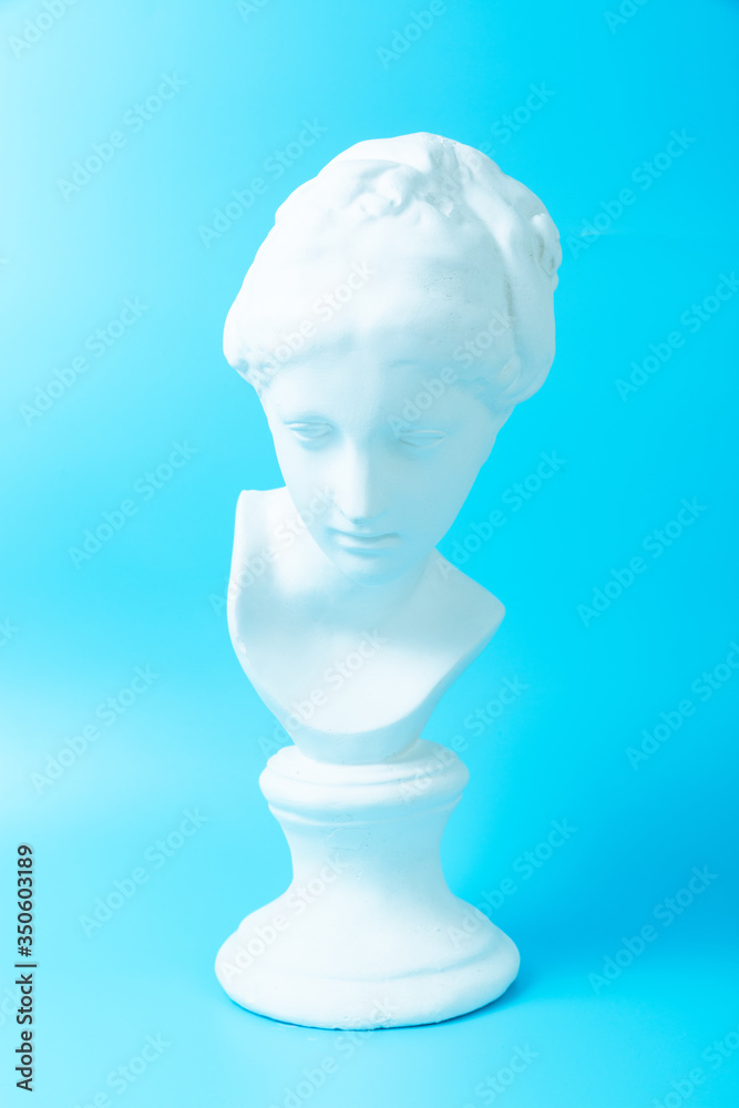Girlish Venus plaster head on blue background