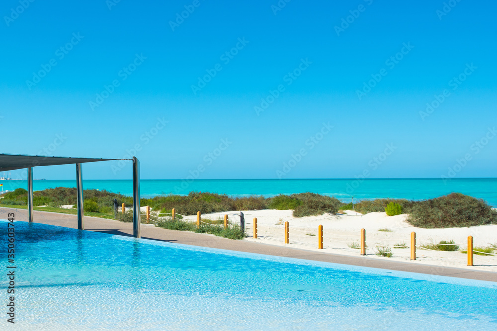 Pool area with sunbeds and umbrellas in luxury hotel Pool area with sunbeds and umbrellas in luxury hotel