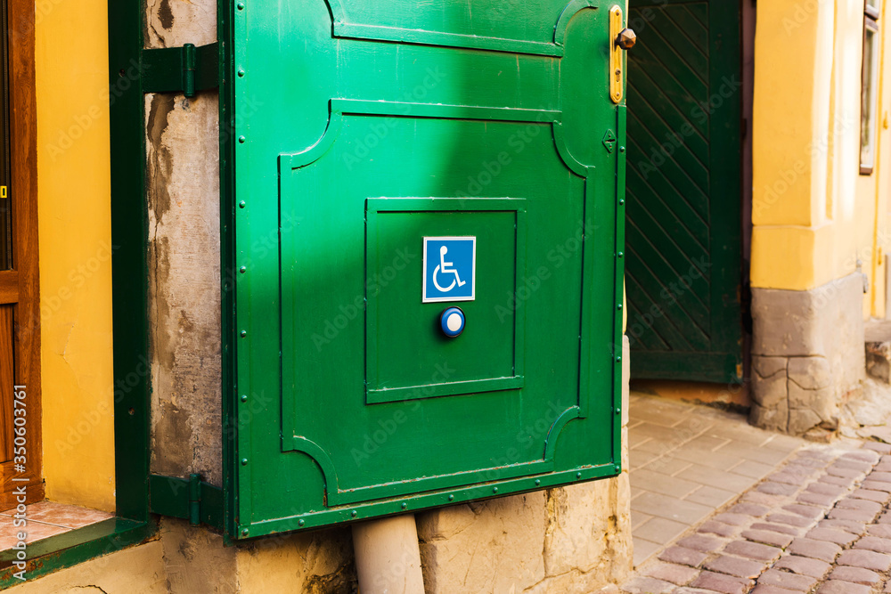 Button on door to call for help to people with disabilities Button on door to call for help to people with disabilities