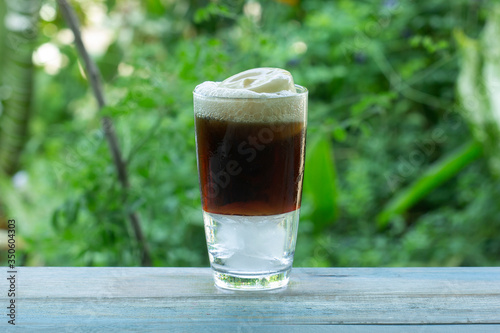 Root beer float a tasty summer treat on Green tree background