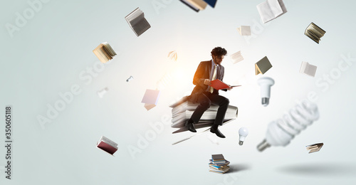 Bild auf Leinwand Man flying on a book