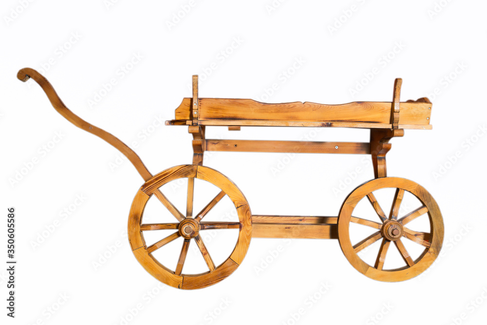 Fototapeta premium Wooden rustic four-wheel cart . onion in wooden cart bags . Wagon wood. Ancient cargo carriage against a red wooden background . Conservative ancient wagon on white background .