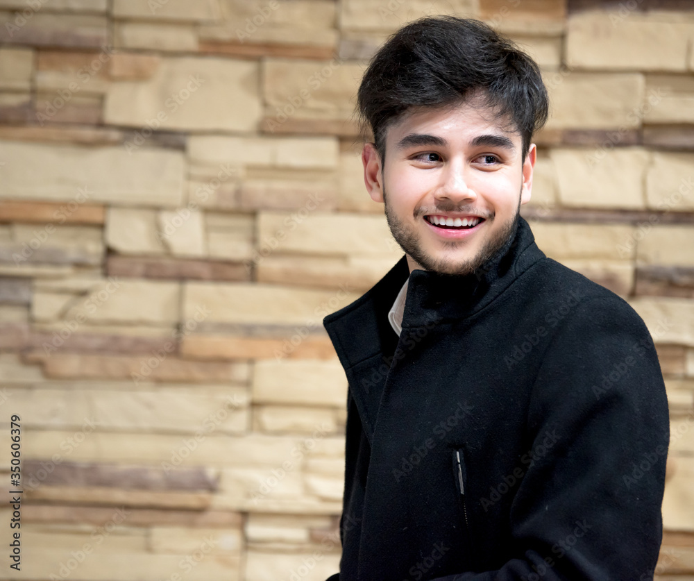 A handsome young male model wearing a black suit A handsome young male model wearing a black suit