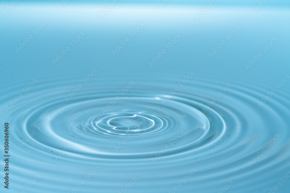 Waves on the surface of the water from a collision. Drop of water drop to the surface.