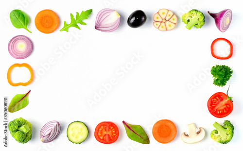 Cook frame with fresh vegetables on white background. Organic raw salad ingredients. Healthy eating concept.  Flat lay, copyspace, top view. 