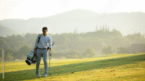 Wallpaper Mural Golfer asian man walking in fairway with bag golf with club in sunlight.  Hobby in holiday and vacation, greed club golf background.   Lifestyle and Sport Concept. Torontodigital.ca