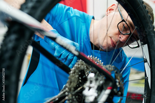 a man repairs a bike in his small business workshop