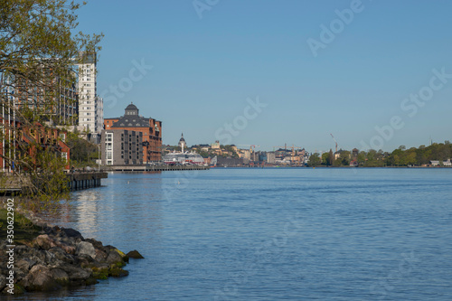 Residential houses by the embankment Nacka Strand and Kvarnholmen at the narrow inlet Blockhusudden to Stockholm a sunny spring day.  © Hans Baath
