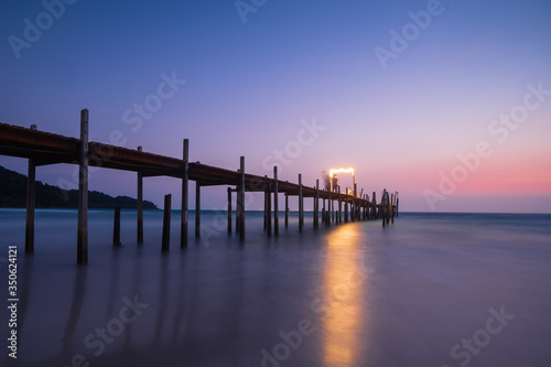 Wood bridge on the sea with a beautiful sunset at koh kood island, Thailand © jackspoon
