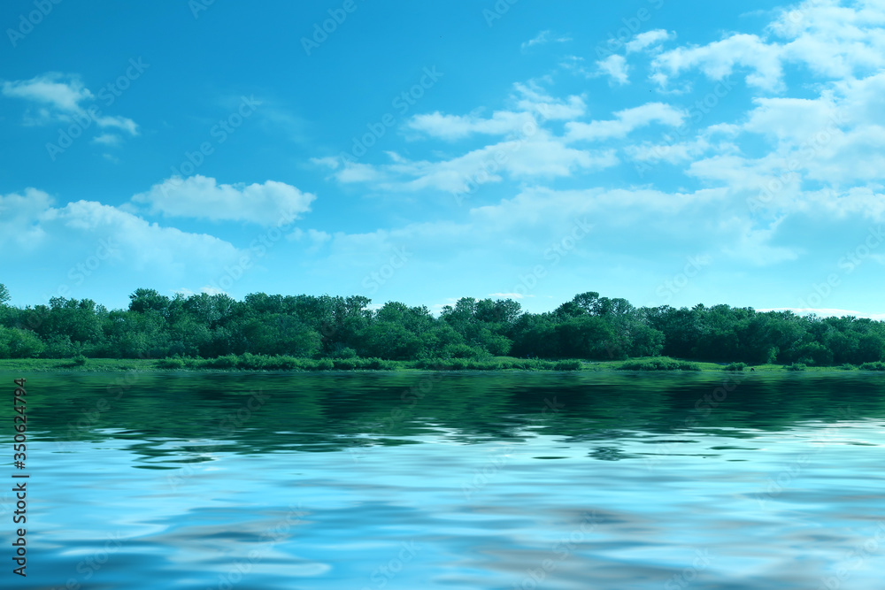 Bright blue sky, forest on the river horizon. Summer landscape.