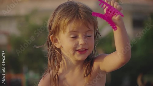 Beautiful little girl dancing and making funny faces