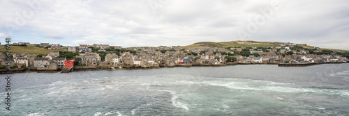 panorama of the historic village Stromness on Orkney mainland, Scotland, Uk. Seaside view of this fisherman town and a harbour at Hoy sound photo