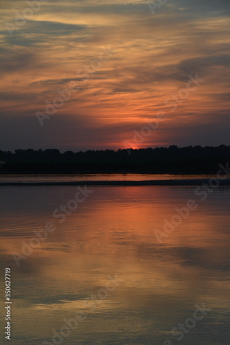 Beautiful sunset on the Volga river. 
The sun is reflected in the river. Russia.