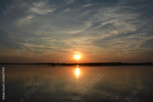 Beautiful sunset on the Volga river.  The sun is reflected in the river. Russia.