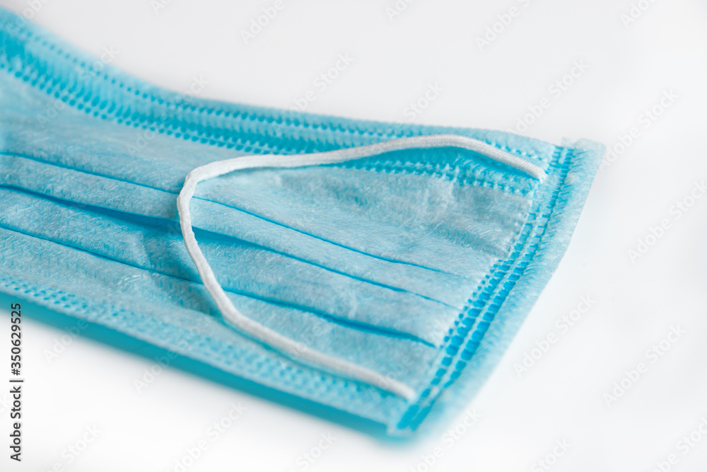 blue medical mask for protection against viruses on quarantined macro shot close at the background blue medical mask for protection against viruses on quarantined macro shot close at the background