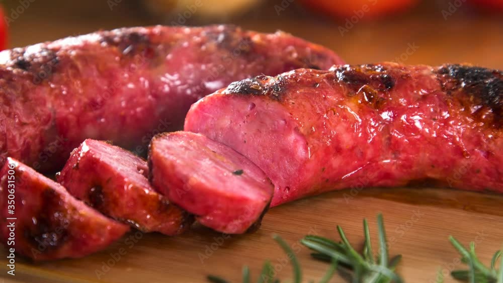 Grilled sausage with smoke. Grilled Sausage on wooden board. Brazilian barbecue. Grilled sausage with smoke. Grilled Sausage on wooden board. Brazilian barbecue.