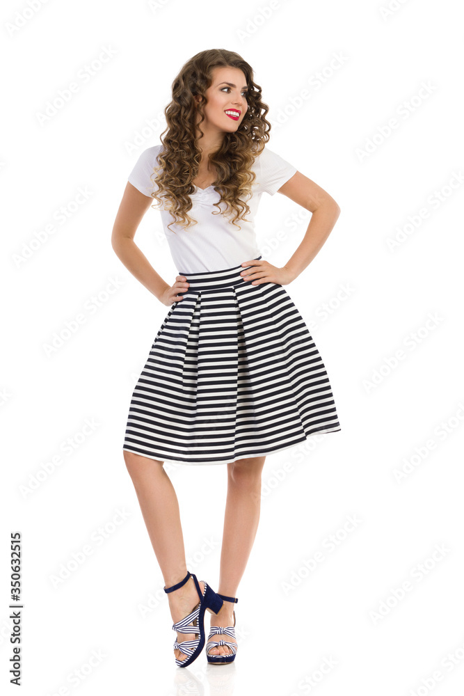 Beautiful Young Woman In Striped Skirt And High Heels Is Looking Away Beautiful Young Woman In Striped Skirt And High Heels Is Looking Away