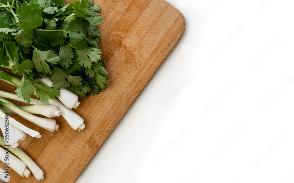 Fresh green onions, parsley lie on the table for the preparation of the salad Fresh green onions, parsley lie on the table for the preparation of the salad
