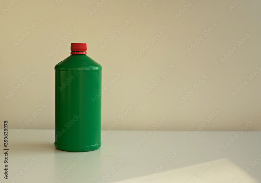 Green bottle on a light background. Space for text Green bottle on a light background. Space for text