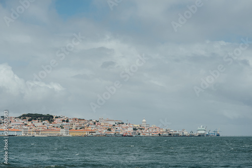 Fototapeta Naklejka Na Ścianę i Meble -  Lisbon panoramic view from the Tagus river (rio Tejo) during the cloudy day