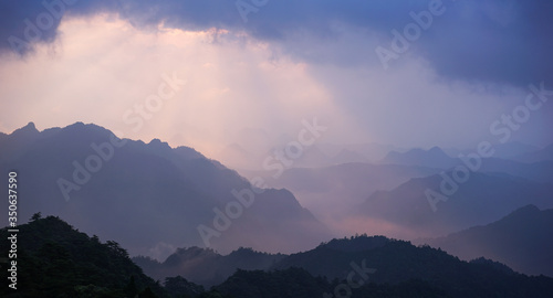 Beautiful glorious colourful sunrise in the national park over the mountains in China, mysterious landscape with hills, clouds, mist and colour shades, trekking and hiking outdoors, peak summit 