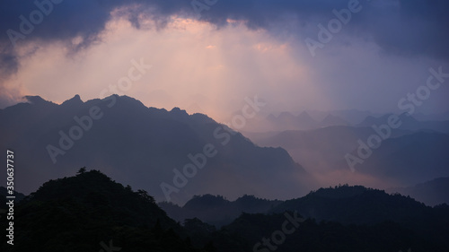 Beautiful glorious colourful sunrise in the national park over the mountains in China, mysterious landscape with hills, clouds, mist and colour shades, trekking and hiking outdoors, peak summit 