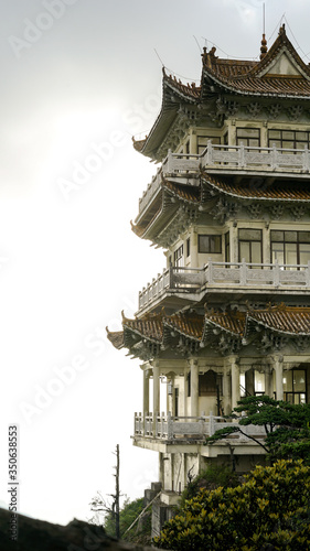 Chinese Buddhist Temple in China, Asia, traditional oriental architecture, monastery on the peak of the hill at the National Nanling Park, sunrise in the early morning, travel and tourism concept photo