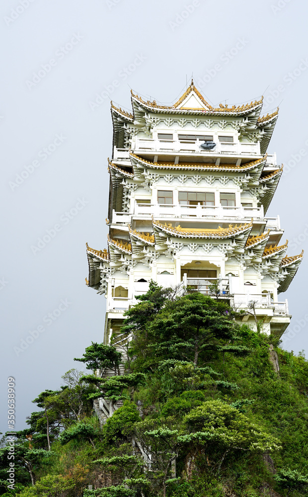Chinese Buddhist Temple in China, Asia, traditional oriental architecture, monastery on the peak of the hill at the National Nanling Park, sunrise in the early morning, travel and tourism concept