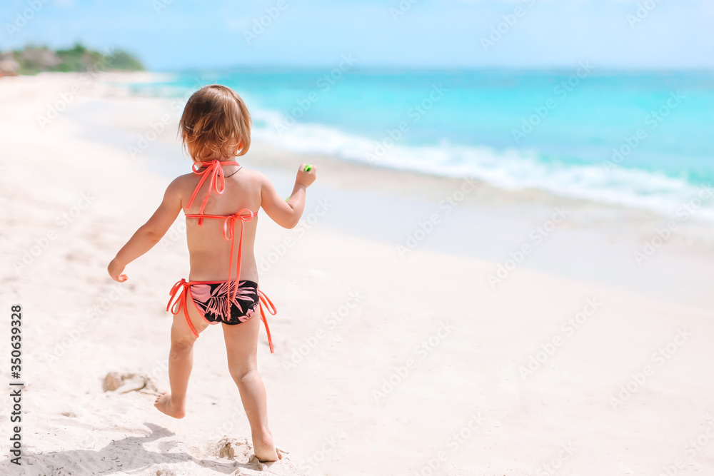 Active little girl at beach having a lot of fun. Active little girl at beach having a lot of fun.