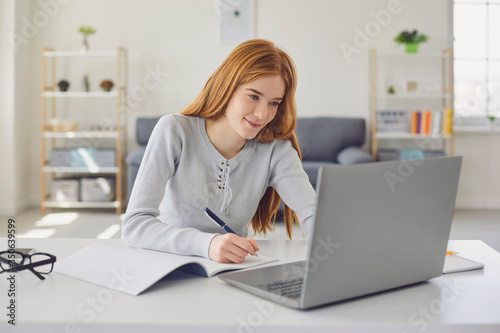 Distance learning.Girl studying a lecture online using a laptop video call at home. Education online course for college university students.