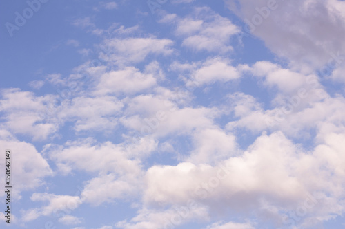 White cumulus and cirrus clouds on a blue sky. Sky background