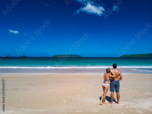 young couple in embrace on a tropical beach