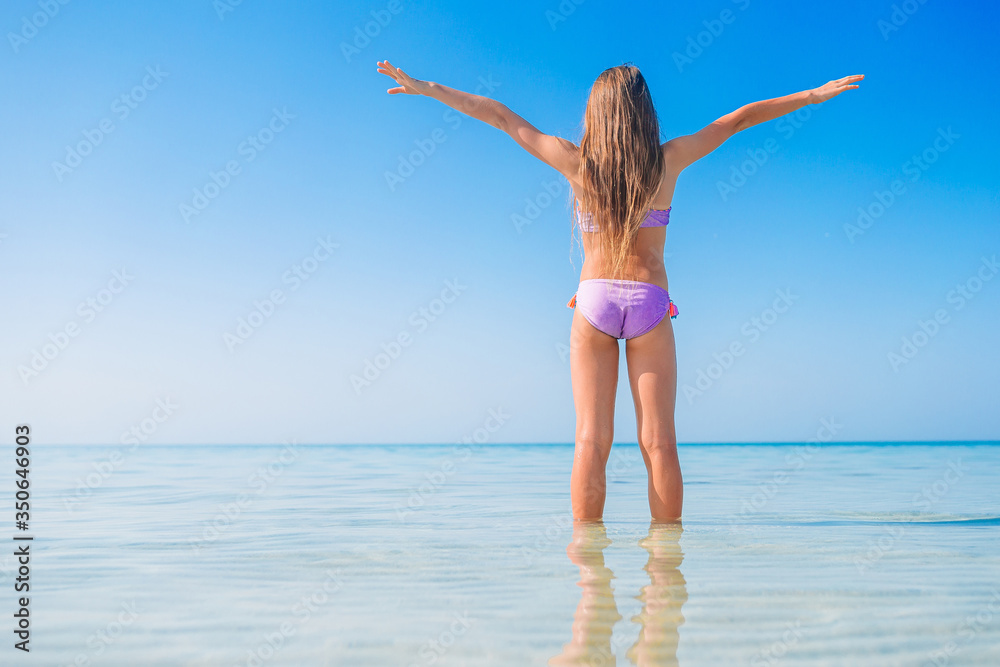 Cute little girl at beach during caribbean vacation Cute little girl at beach during caribbean vacation