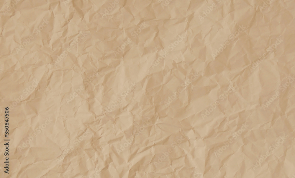 Crumpled pastel peach paper texture background