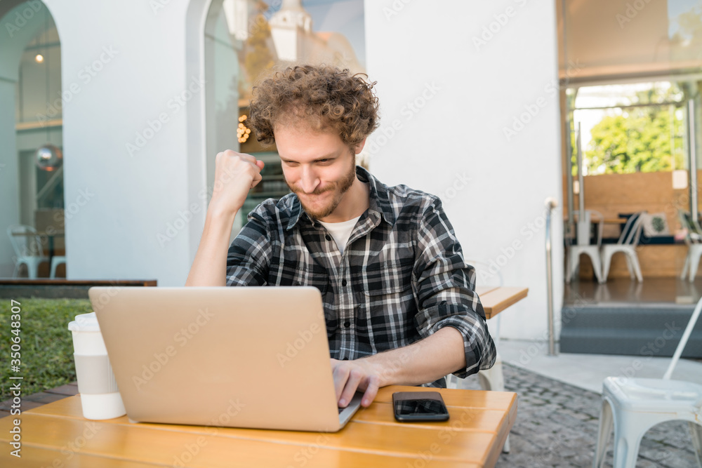 Happy man looking at laptop and celebrating good news. Happy man looking at laptop and celebrating good news.