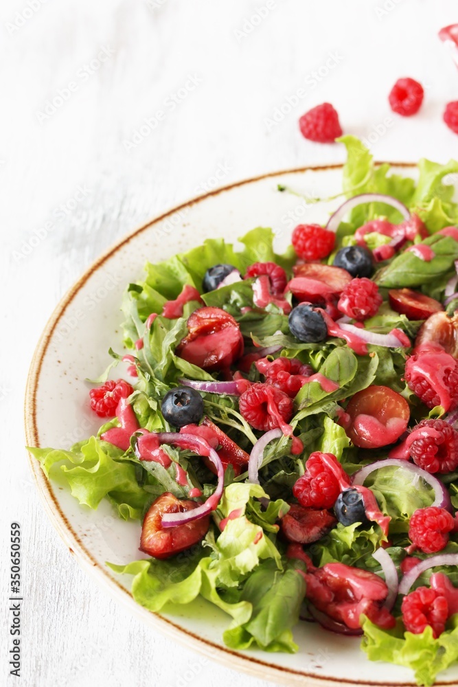 Salad with berries-raspberry, blueberry, sweet cherry. Dressed with raspberry vinaigrette. Soft focus. copy space Salad with berries-raspberry, blueberry, sweet cherry. Dressed with raspberry vinaigrette. Soft focus. copy space