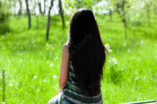 woman sitting in bench in garden