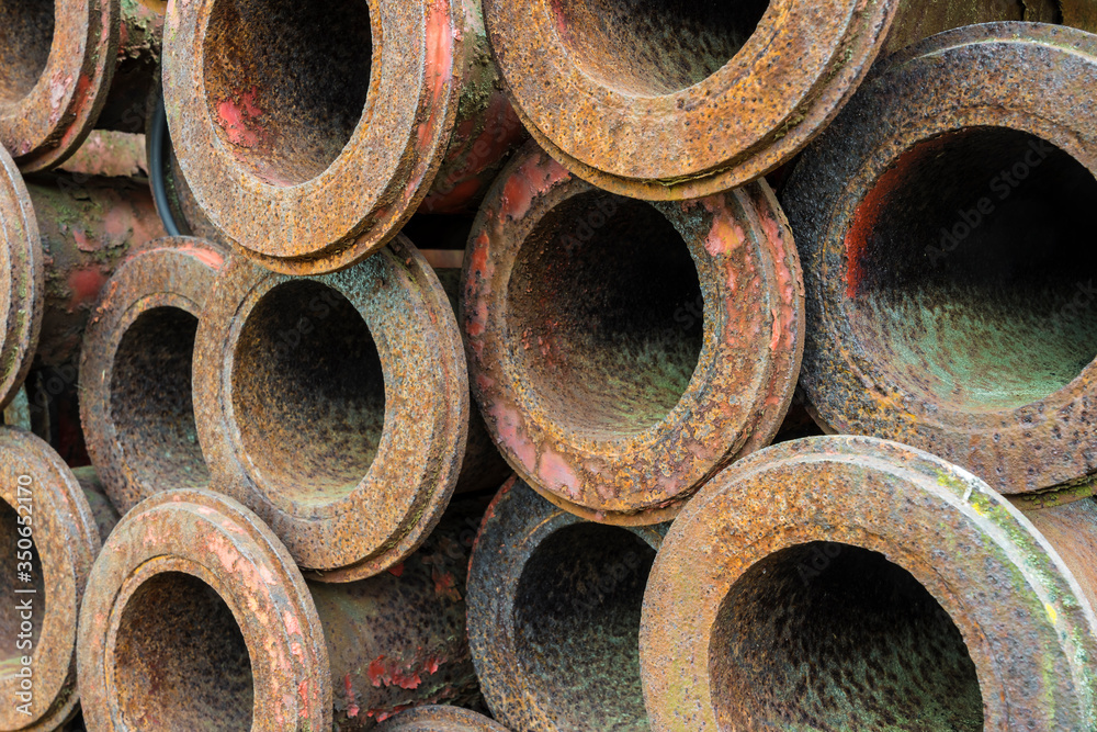 stack of old rusty metal pipes