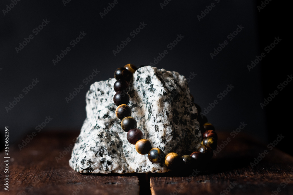 men stone bracelet on a rock isolated men stone bracelet on a rock isolated