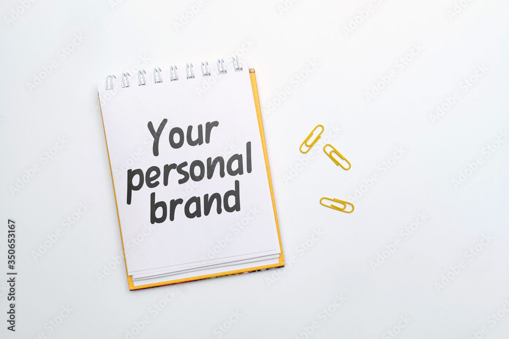 Hand lettering in a notebook your personal brand on a white background. Hand lettering in a notebook your personal brand on a white background.
